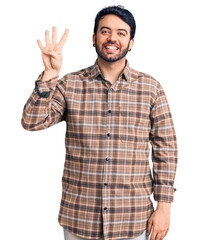 Young hispanic man wearing casual clothes showing and pointing up with fingers number four while smiling confident and happy.