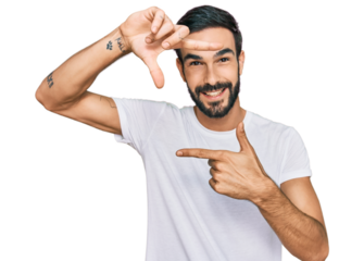 Young hispanic man wearing casual white t shirt smiling making frame with hands and fingers with happy face. creativity and photography concept.