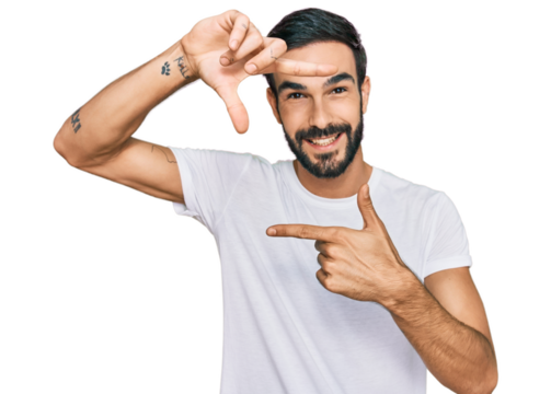 Young hispanic man wearing casual white t shirt smiling making frame with hands and fingers with happy face. creativity and photography concept.