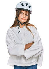 Teenager caucasian girl wearing bike helmet skeptic and nervous, disapproving expression on face with crossed arms. negative person.