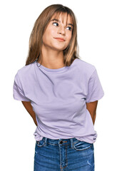 Obraz premium Teenager caucasian girl wearing casual clothes smiling looking to the side and staring away thinking.