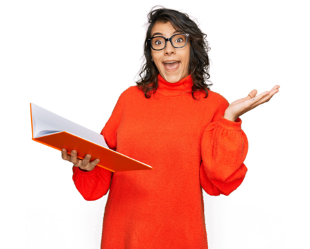 Young hispanic woman reading a book wearing glasses celebrating victory with happy smile and winner expression with raised hands