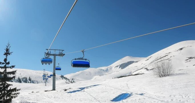 POV from Ski Chair Lift to Snowy Ski Slope, Skiers Slide on Ski Slope