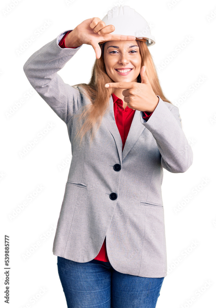 Canvas Prints Beautiful young woman wearing architect hardhat smiling making frame with hands and fingers with happy face. creativity and photography concept.