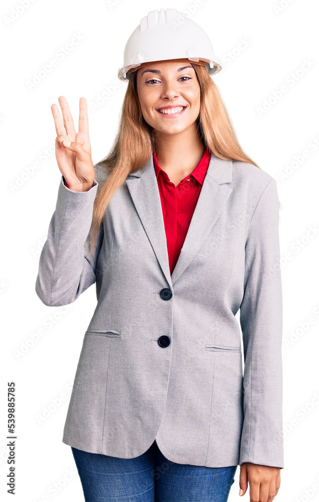 Canvas Prints Beautiful young woman wearing architect hardhat showing and pointing up with fingers number three while smiling confident and happy.