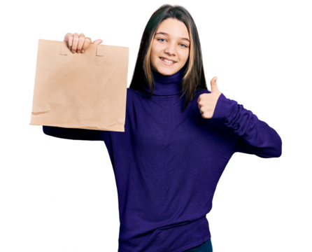 Young brunette girl with long hair holding take away paper bag smiling happy and positive, thumb up doing excellent and approval sign