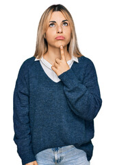 Young caucasian woman wearing casual clothes thinking concentrated about doubt with finger on chin and looking up wondering