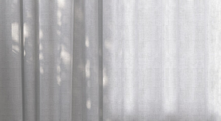 Sunlight from window cast beautiful foliage tropical leaf shadow pattern on empty white curtain...