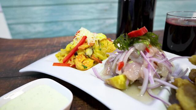 seafood trio, rice with seafood, ceviche, fish chicharon, chicha morada drink.