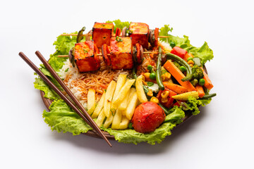 Paneer Sizzler is an Indian version with cottage cheese, salad served sizzling on hot stone dish.