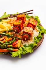 Paneer Sizzler is an Indian version with cottage cheese, salad served sizzling on hot stone dish.