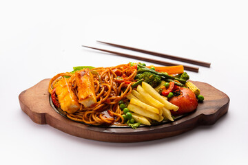 Paneer Sizzler is an Indian version with cottage cheese, salad served sizzling on hot stone dish.