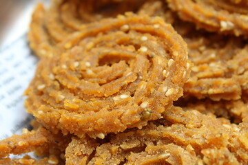 Indian Traditional Tea Time Snack Chakli, a deep fried snack, It is known as Chakali, Murukku, Muruku, Murkoo, Chakri. Chakali closeup 