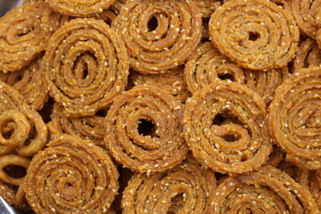Indian Traditional Tea Time Snack Chakli, a deep fried snack, It is known as Chakali, Murukku, Muruku, Murkoo, Chakri. Chakali closeup 