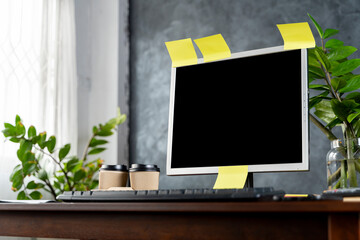 Contemporary office and computer monitor with blank screen on the desk technology and business concept.