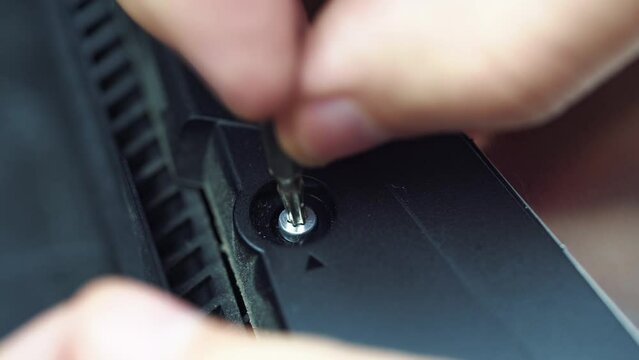 Repairman selects a suitable torx key for the bolt to unscrew it