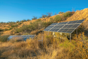 Solar panels generating renewable green energy against blue sky on a sunny day
