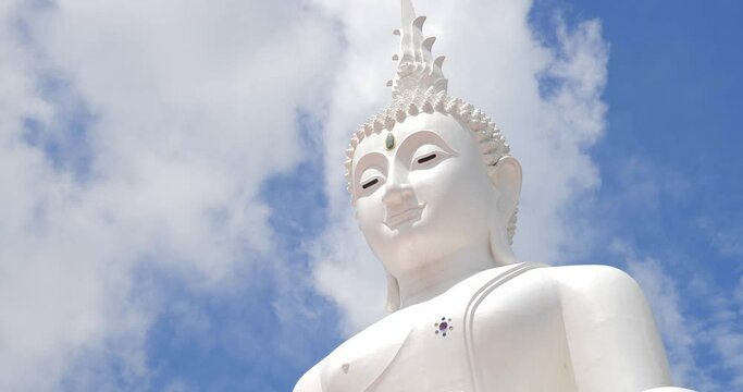 White buddha statue with bright sky background