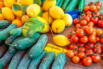 Pickles, tomatoes and lemons for sale at a market