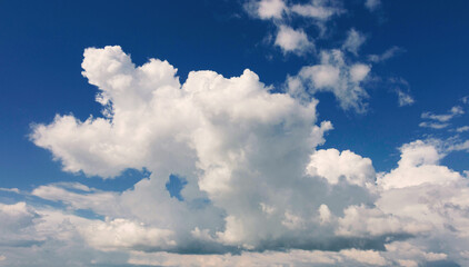 white fluffy clouds over clear blue sky