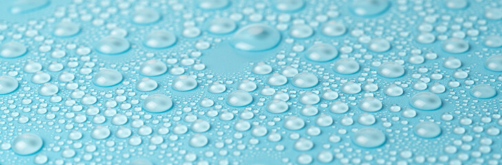 Water drops on a blue background close-up