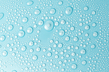 Water drops on a blue background close-up