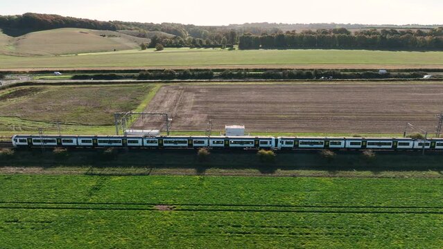 Commuter Train Passing Over a Level Crossing with Vehicles