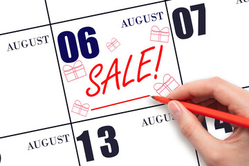 Hand writing text SALE and drawing gift boxes on calendar date August 6. Shopping Reminder