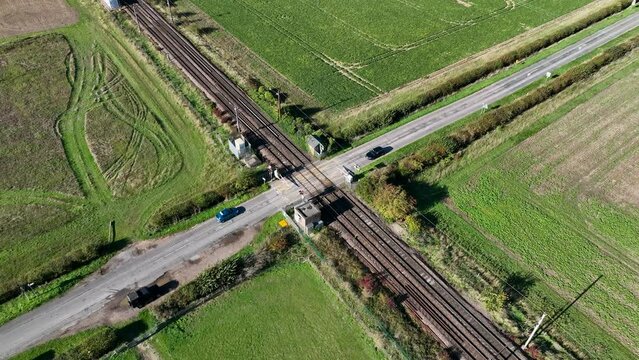 Fast Commuter Train Passing Over a Level Crossing