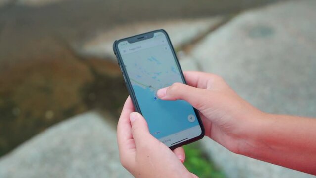 Young woman typing on her phone on a foggy morning in nature