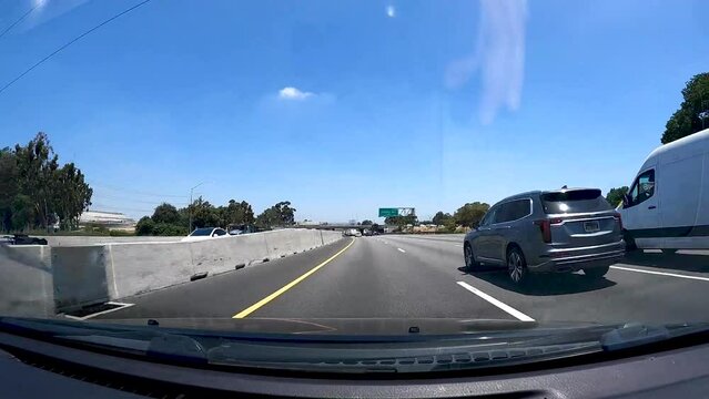 Time lapse of driving on Southern California Freeway with large trucks on sunny day