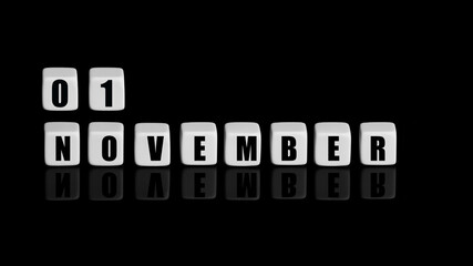 November 1st. Day 1 of month, Calendar date. White cubes with text on black background with reflection. Autumn month, day of year concept