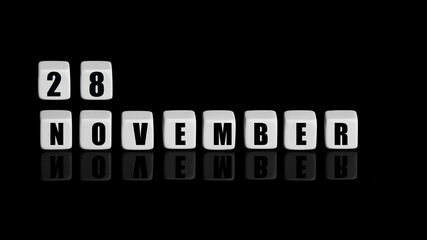 November 28th. Day 28 of month, Calendar date. White cubes with text on black background with reflection. Autumn month, day of year concept