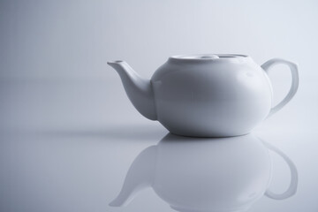 White teapot isolated on white  with reflection