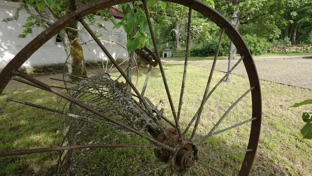 The rusty and broken wheels outside the house in the yard in Estonia