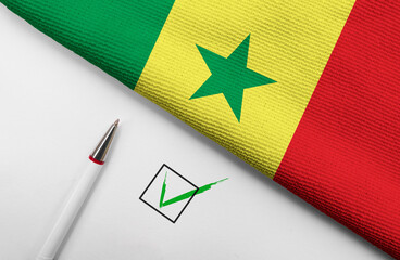 Pencil, Flag of Senegal and check mark on paper sheet
