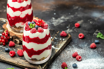 Scottish dessert whipped cream, roasted oatmeal and raspberries in jar. banner, menu, recipe place for text, top view