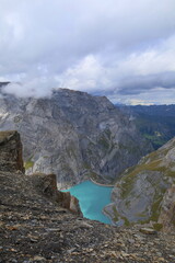 Limmerensee reservoir surrounded by Muttenchopf mountain and Muttsee mountain lake in Glarus, Switzerland