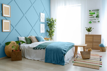 Interior of beautiful modern bedroom with light blue wall