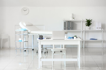 Interior of medical office with doctor's workplace and couch