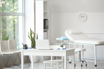 Interior of modern medical office with doctor's workplace