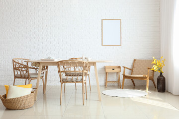 Fototapeta na wymiar Interior of dining room with modern furniture near white brick wall