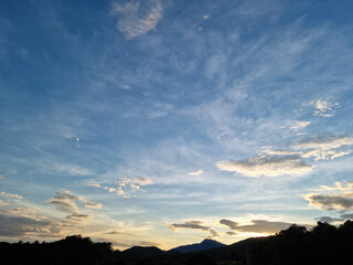 cloud and vanilla sky background with dark mountain silhouette
