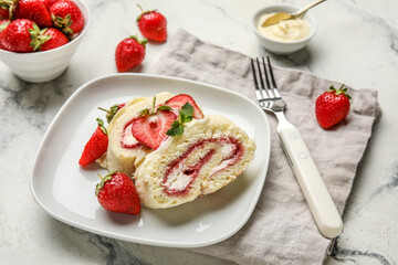 Plate with slices of sweet strawberry roll cake on light background