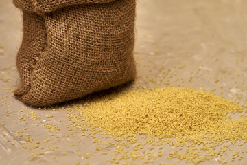 croup couscous poured out of a canvas bag on the table