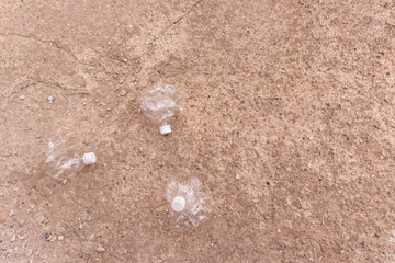 a small crushed water bottle on the ground