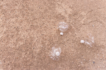 a small crushed water bottle on the ground