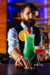 Close up of barman decorate blue lagoon cocktail