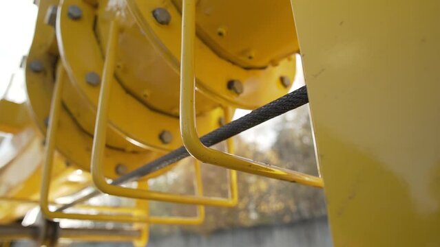 Steel cable rope of electric drum hoist winch of yellow construstion crane. 