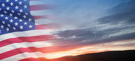 Obraz premium United States of America flag on sky at sunset or sunrise background. Independence day, Memorial day, Veterans day. Banner.